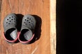 A pair of old shoes a brown wooden board. Royalty Free Stock Photo