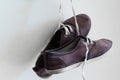 A pair of old sports shoes hanging on the wall Royalty Free Stock Photo