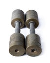 A pair of the old style dust covered variable weight copper dumbbells isolated on white background