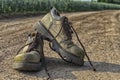 Pair of old worn hiking boots an a gravel path Royalty Free Stock Photo