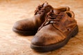 Pair of old worn shoes on wooden boad Royalty Free Stock Photo