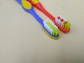 a pair of orange and blue toothbrushes