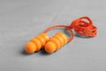 Pair of orange ear plugs with cord on grey background, closeup Royalty Free Stock Photo