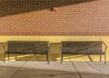 Pair of outdoor benches in front of brick