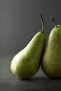 A pair of pears on a dark background