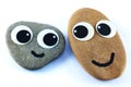 A pair of pebbles with goggle eyes and happy smiles.