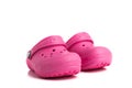 Pair of pink baby Crocs sandals isolated on white background. Close-up