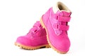 Pair of pink children nubuck boots with velcro fasteners for girls isolated
