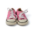 Pair of pink children`s textile sneakers with white laces isolated on a white background Royalty Free Stock Photo
