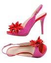 Pair of pink female open-toe shoes over white