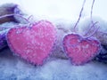 A pair of pink hearts of felt on the snow