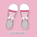 A pair of pink sneakers on pink background