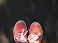 a pair of pink sneakers on the wet asphalt Royalty Free Stock Photo