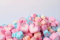 Pair of Pink and White Heart Shaped Marshmallow on the Pile of Pastel Color Flower Shaped Marshmallow Candies with Free Space