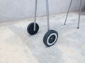 A pair of plastic wheels from a mobile grill