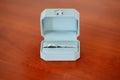 Pair of platinum wedding rings in the box and ring with diamond