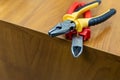 Pair of pliers working tool engineer construction repair edge on a wooden table Royalty Free Stock Photo