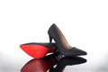 Pair of pointed woman shoes with black soles red high heels Royalty Free Stock Photo