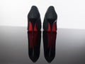 Pair of pointed woman shoes with black soles red high heels Royalty Free Stock Photo