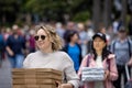 Pair of pretty young women delivering stack of pizza boxes in Sydney harbour, Sydney, Australia