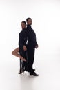 Pair of professional dancers standing back