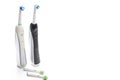 Pair of Professional Electric Toothbrushes With Spare Attachments Placed Together on White Background