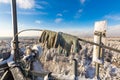 Pair of protective gloves of worker-climber is on the top of telecommunication tower with vertical panel antennas and Royalty Free Stock Photo