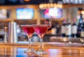 Two Purple Cocktails in Martini Glasses