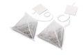 Pair of pyramid tea bags and blank label on white background Royalty Free Stock Photo