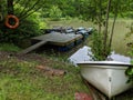 A pair of rafts on a pontoon with a small rowing boat on the shore bank Royalty Free Stock Photo