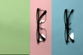 Pair of reading glasses isolated on three colored background. Fashion spectacles for man and woman