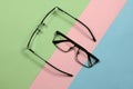 Pair of reading glasses isolated on three colored background. Fashion spectacles for man and woman