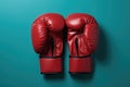 A pair of red boxing gloves on a blue background. Generative AI image. Royalty Free Stock Photo