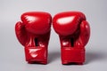 A pair of red boxing gloves on gray background Royalty Free Stock Photo