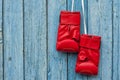 Pair of red boxing gloves hanging on a nail Royalty Free Stock Photo