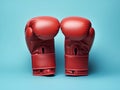 Pair of red boxing gloves on light blue background. Active sports, minimalistic sports banner template. Gloves for box training, Royalty Free Stock Photo
