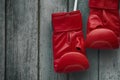 Pair of red boxing gloves on an old shabby wooden wall Royalty Free Stock Photo