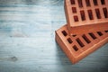 Pair of red bricks on wood board construction concept Royalty Free Stock Photo