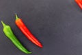 Pair red bright pod hot chili peppers green oblique vegetable corner on a black background