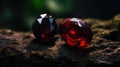 a pair of red diamonds sitting on top of a rock