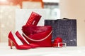 Pair of elegant leather women shoes with high heels and woman purse in the background on the shelf at the shoe store