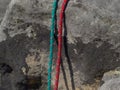 Pair of red and green climb ropes in detail. Used light rope