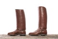 Pair of red handmade old boots on wooden floor isolated over white background Royalty Free Stock Photo