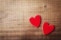 Pair of red hearts on vintage wooden table top view. Saint Valentines day greeting card.