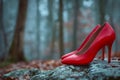 A pair of red high heels sitting on a rock in the woods. Generative AI Royalty Free Stock Photo