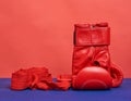 Pair of red leather boxing gloves on a blue background, sports equipment Royalty Free Stock Photo