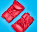 Pair of red leather boxing gloves on a blue background Royalty Free Stock Photo