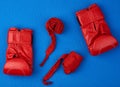 Pair of red leather boxing gloves and a textile red elastic bandage for hands Royalty Free Stock Photo