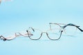 Pair of red plastic-rimmed eyeglasses on a blue background Royalty Free Stock Photo