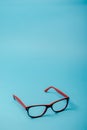 pair of red plastic-rimmed eyeglasses